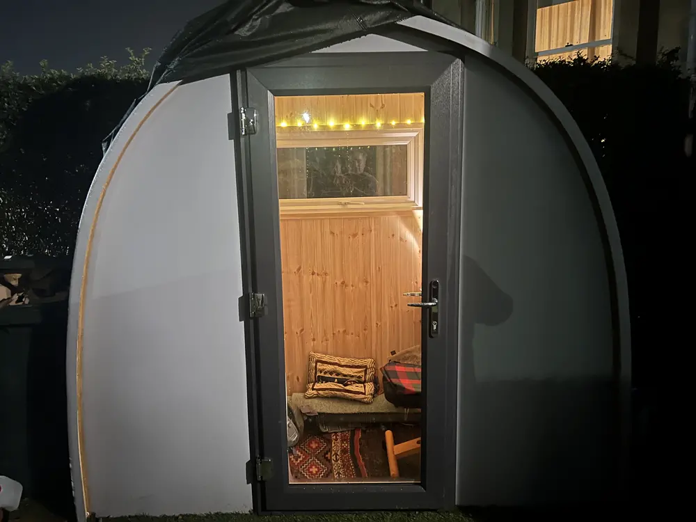 Alexander's Dory Office Pod lit up at night
