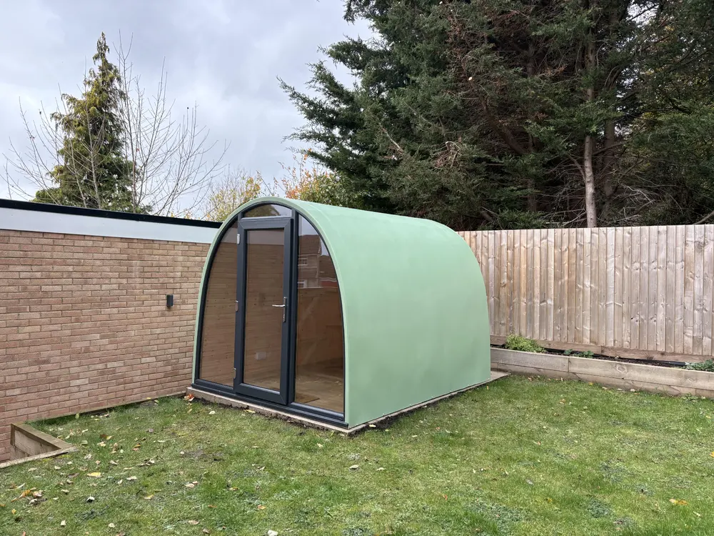 Andrew Hussey's green glass-fronted Skipjack Pod in his garden