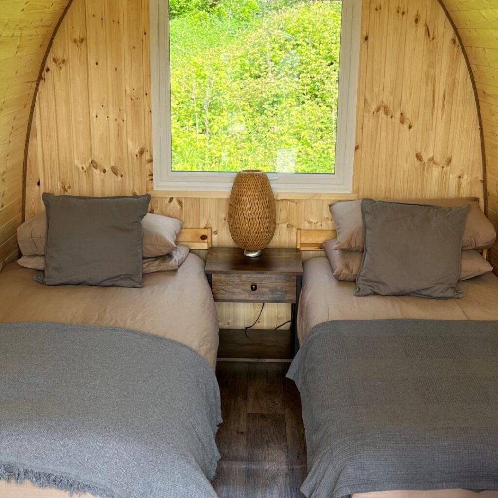 Starting a Glamping Business: Standard Campsite Size Outdoor Pods | Image Description: Glamping Pod featuring two camping beds