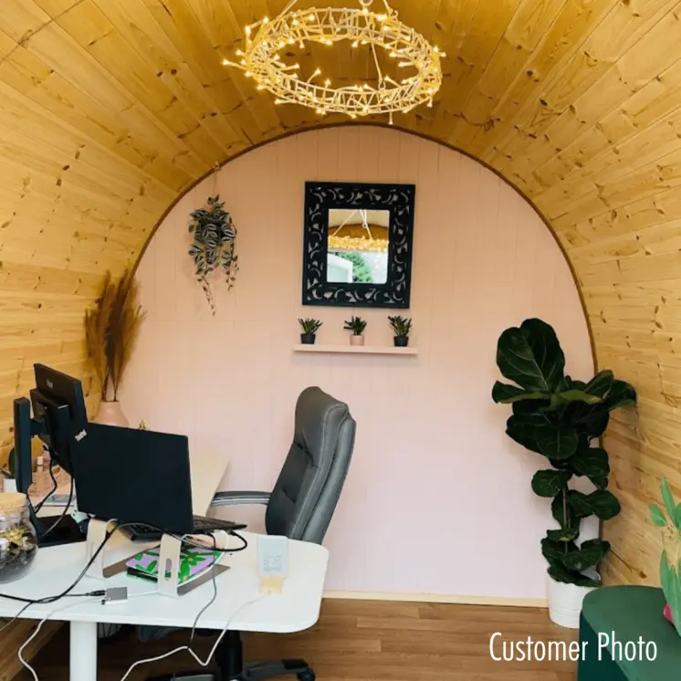 A modern Hully Pod garden office nestled among vibrant garden foliage, offering a serene work-from-nature experience.