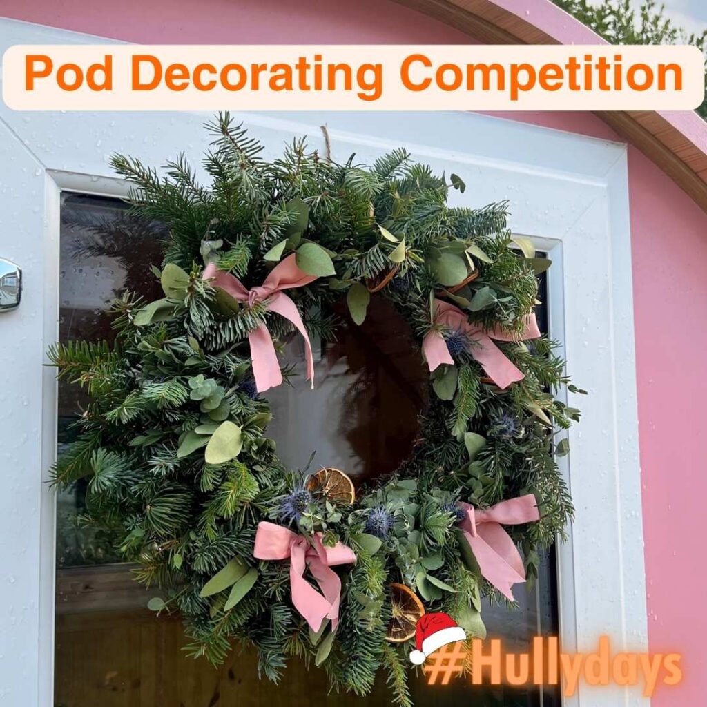 Holiday decor with Hully Pods for Hullydays competition | Image: Green wreath with pink ribbons on door of Pink Hully Pod